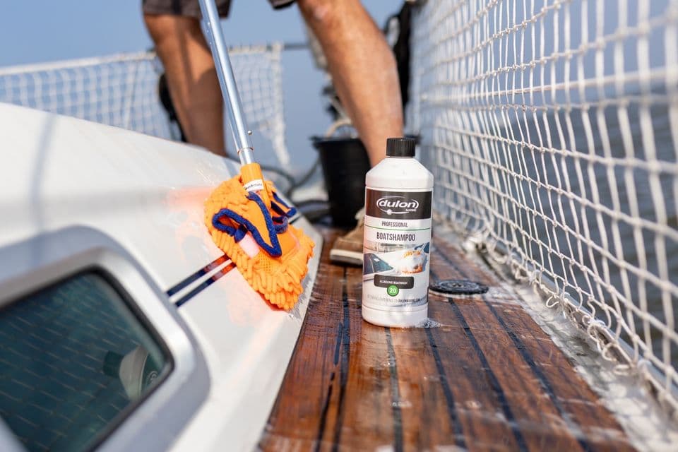 Cleaning a boat deck with a Dulon Marine cleaner and deck brush